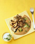 Broccoli pancakes with mushrooms and yogurt on plate, for strong bones