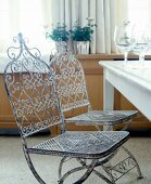 Two folding metal chairs with table