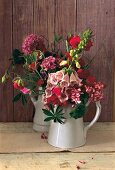 Two bouquets of summer flowers in vases