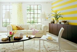 View of bright living room with big white sofa