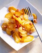 Fried potatoes with fork in bowl