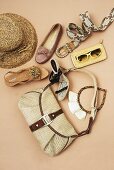 Ethnic and safari shoes, belt, handbag, hat and other accessories on beige background