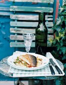 Fried char with potato salad on plate