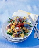 Fish salad with green beans on plate