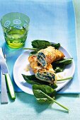 Spinach pancakes with goat cheese on plate