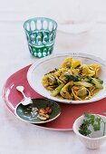 Tortelloni with herb butter and asparagus on plate