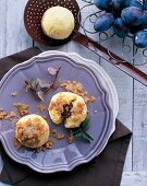 Homemade plum dumplings with vanilla brown butter on plate