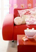 Asian style floral patterned pillows on red armchair