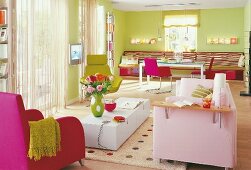 View of living room with green walls and pink and green furniture
