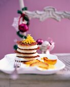 A tower of ginger mousse on a table laid for Christmas