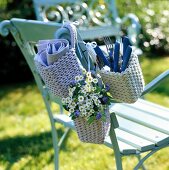 Wicker baskets with cutlery and napkin holder on chair