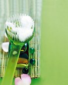 Close-up of foam on green bathroom brush