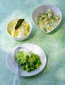 Three bowls of potatoes with asparagus in bowl