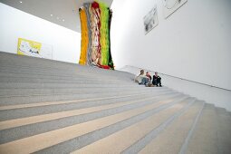 People sitting in Pinakothek der Moderne Museum in Munich, Germany