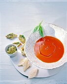 Tomato soup with olive crostini on serving dish