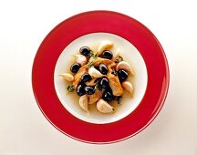 Andalusian chicken with black olives on serving dish