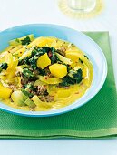 Spinach curry with hack potato on plate