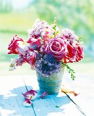 Close-up of fresh bouquet of pink roses, Allium and Delphinium on table