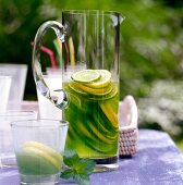 Drink with lime and alcohol in glass jar