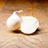 Close-up of white onion kept on wooden surface