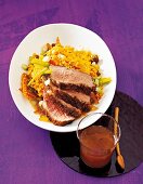 Duck breast with couscous served on plate
