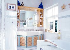 Bathroom in white with wooden features and giant mirror above sink