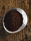 A plate of black mustard seeds (seen from above)
