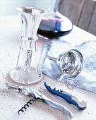 Decanting steel accessories with champagne opener on table