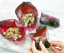 Cooked beef wrapped in red cabbage leaves