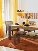 African styled dining room with wooden dining table and chair in yellow tones