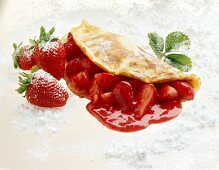 Pancakes with strawberries and strawberry sauce
