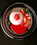 Strawberry cream with pistachios and fresh strawberries, overhead view