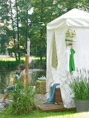 Garden shower and woman sitting on wood