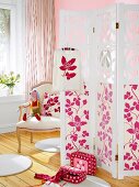 Room with folding screen with pink floral print, chair