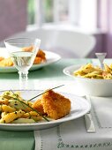 Asparagus and potato salad with crispy schnitzel on plate