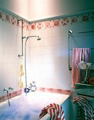 Bathroom with red and white tiles and bubble in bathtub