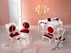 Necklaces on dollhouse furniture with chandelier