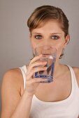 Portrait of woman drinking glass of water
