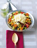 Vegetable couscous with raisins and chick peas in bowl