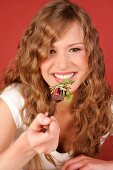 Pretty woman holding bowl of salad and fork, smiling