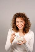 Woman holding dessert bowl in hand