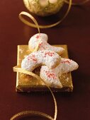 Walnut kipferl (crescent-shaped biscuits) with icing sugar on a golden square