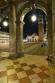 View of arches and columns of St. Mark's Square at night