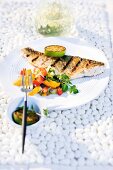 Grilled zander fillet with coriander, fennel, cucumber and mango salad served on plate