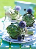 Artichokes tied together with thistle flowers as place setting decorations