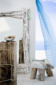 An artistically made mirror, stool and side table made from driftwood