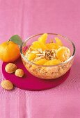 Winter cereal with orange and tangerine in glass bowl