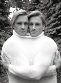Portrait of two blonde men wearing white sweater, black and white