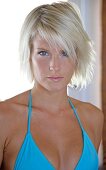 Portrait of beautiful grey eyed blonde woman wearing light blue bikini