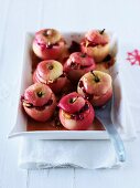 Baked apples with white chocolate sauce, cranberries and almonds